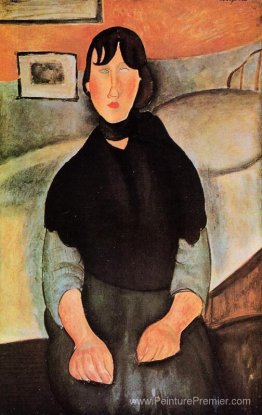 Jeune femme sombre assise par un lit Jeune femme sombre assise par un lit