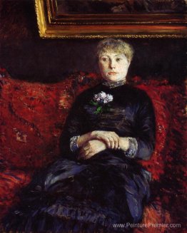 Femme assise sur un canapé à fleurs rouges Femme assise sur un canapé à fleurs rouges